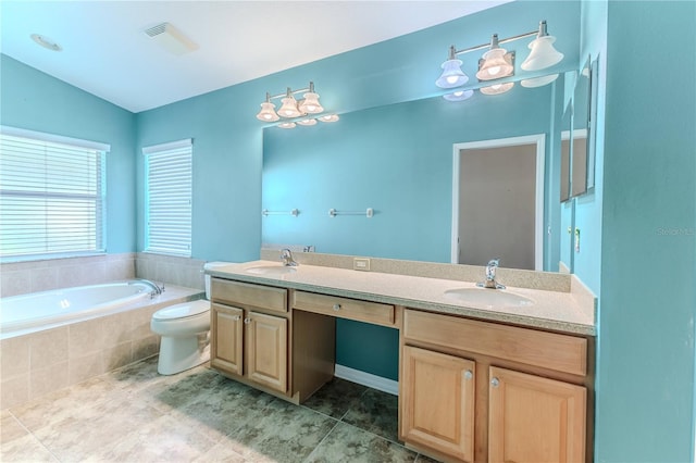 bathroom with double vanity, a bath, visible vents, and a sink