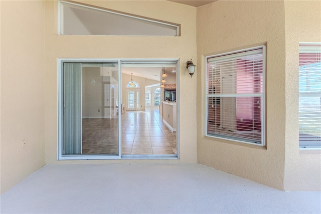 property entrance with stucco siding