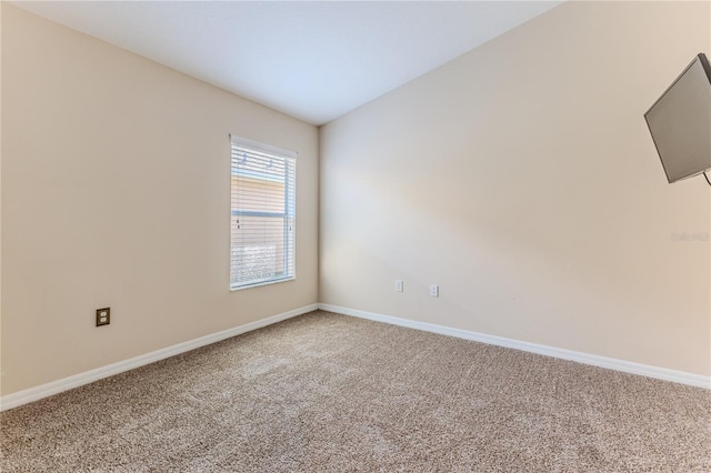 empty room with carpet flooring and baseboards