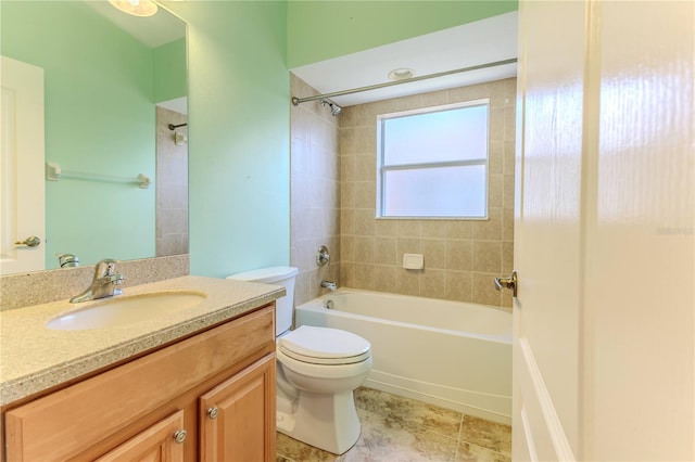 full bathroom featuring tile patterned flooring, toilet, tiled shower / bath combo, and vanity