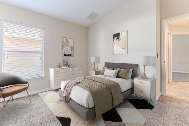 bedroom featuring baseboards, visible vents, and light colored carpet