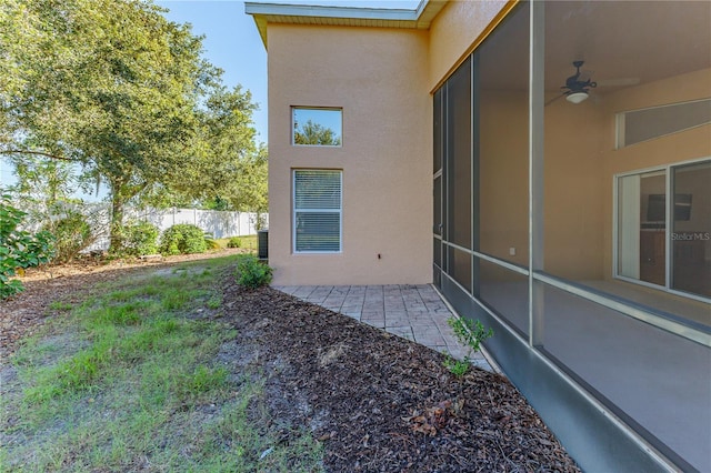 exterior space with stucco siding, fence, and a patio