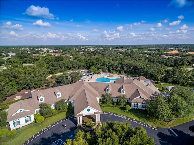 drone / aerial view featuring a wooded view