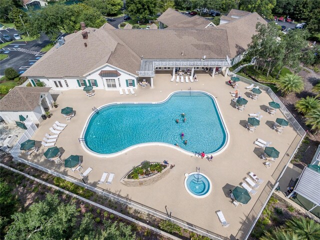 community pool with a pergola and a patio