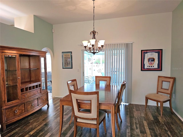 dining area with a chandelier and dark wood-type flooring