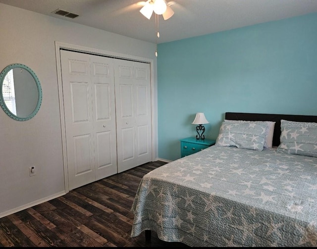 bedroom with visible vents, baseboards, a closet, dark wood-style floors, and a ceiling fan