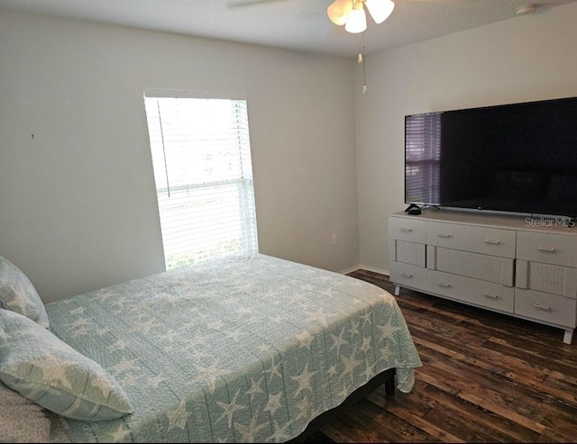 bedroom featuring dark wood finished floors, baseboards, and ceiling fan