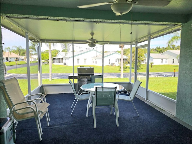 sunroom featuring ceiling fan