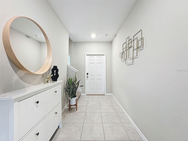 doorway to outside with light tile patterned floors