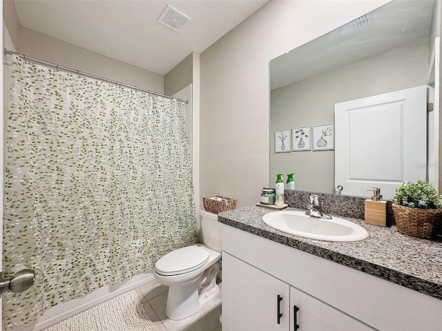 bathroom with a textured ceiling, vanity, a shower with shower curtain, tile patterned flooring, and toilet