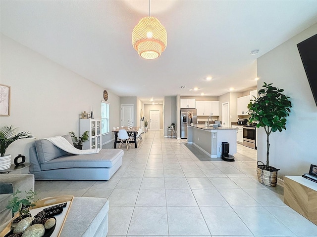 living room featuring sink and light tile patterned floors