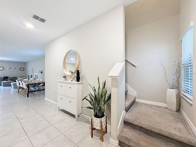 stairway featuring tile patterned flooring