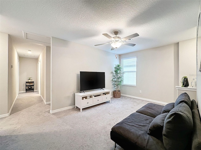 living room featuring a textured ceiling, light colored carpet, and ceiling fan