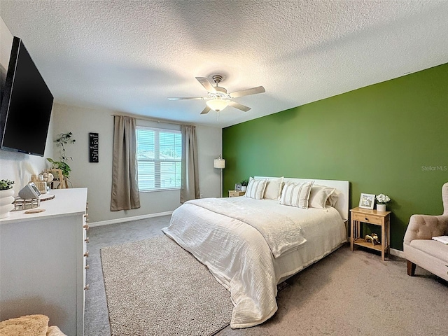 bedroom with a textured ceiling, carpet, and ceiling fan