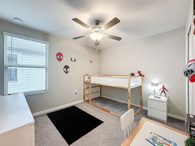 bedroom featuring carpet flooring, a textured ceiling, and ceiling fan