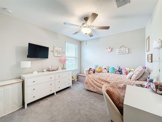 carpeted bedroom with a textured ceiling and ceiling fan