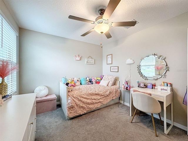 carpeted bedroom featuring a textured ceiling and ceiling fan