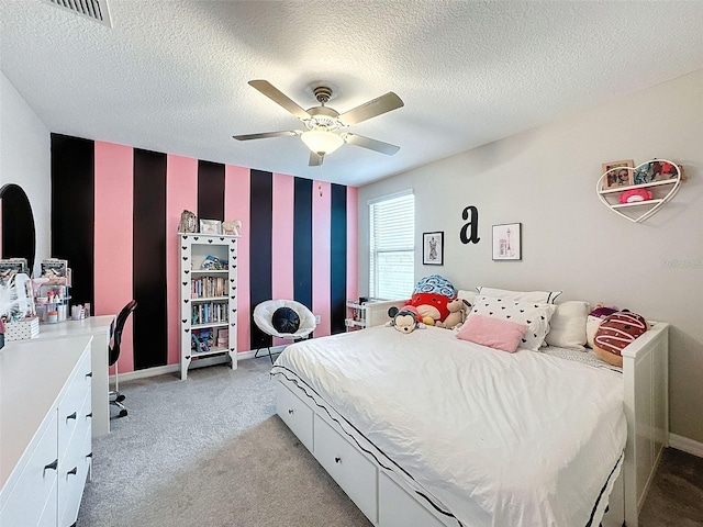 bedroom with a textured ceiling, light colored carpet, and ceiling fan