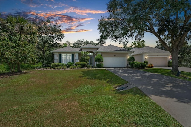 single story home with a lawn and a garage