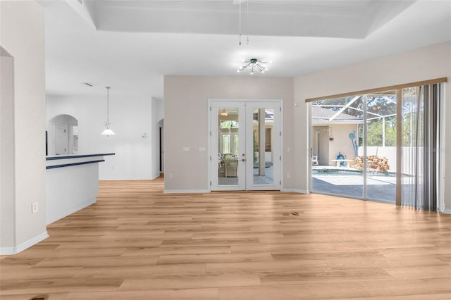 unfurnished dining area featuring french doors and light hardwood / wood-style flooring