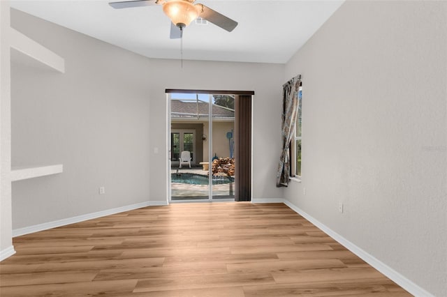 empty room featuring light wood-type flooring and ceiling fan