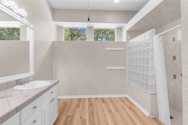 bathroom with vanity, hardwood / wood-style flooring, and walk in shower