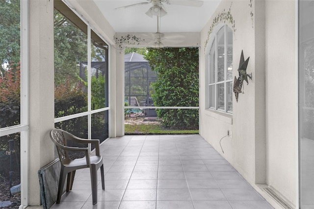 sunroom featuring ceiling fan