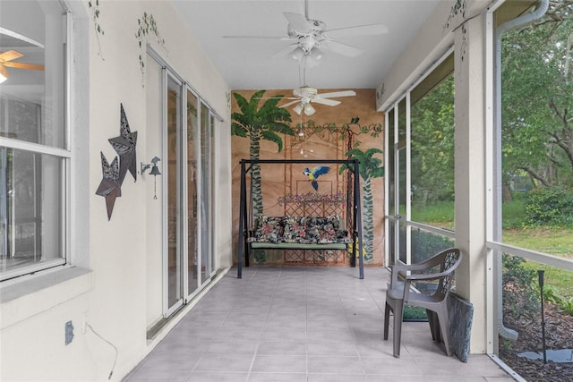 sunroom / solarium featuring ceiling fan