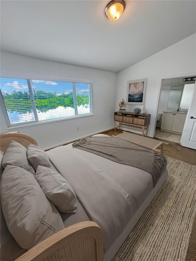 bedroom featuring lofted ceiling and hardwood / wood-style flooring