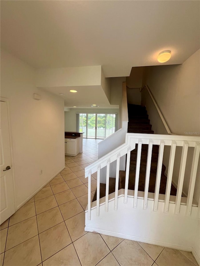 staircase with tile patterned flooring