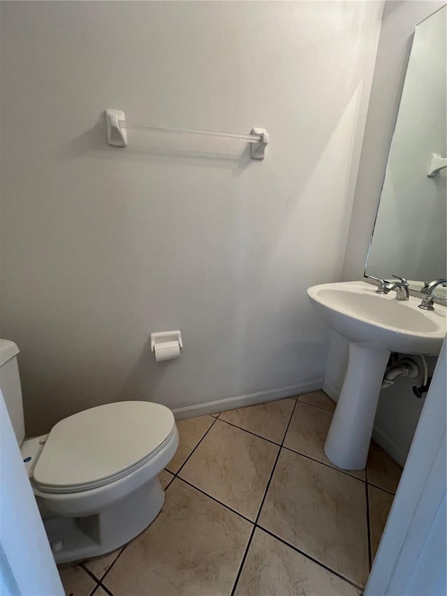 bathroom featuring tile patterned flooring and toilet