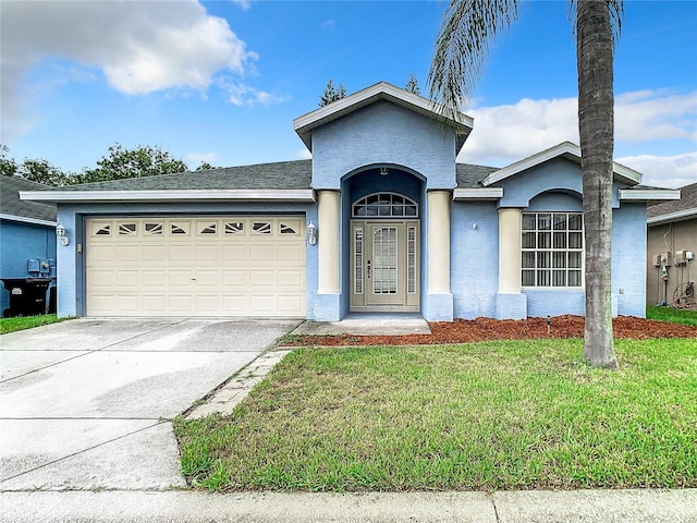 single story home featuring concrete driveway, roof with shingles, an attached garage, a front lawn, and stucco siding