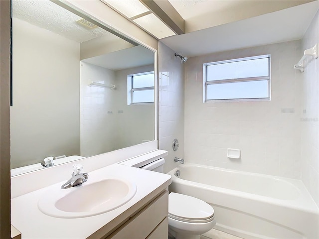 bathroom featuring washtub / shower combination, visible vents, vanity, and toilet