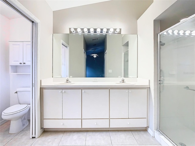 full bathroom with tile patterned flooring, a shower stall, and a sink