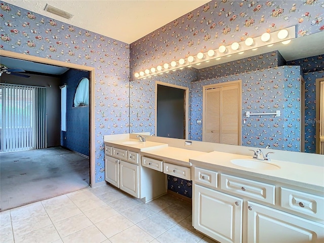 bathroom with ceiling fan, vanity, and tile patterned flooring