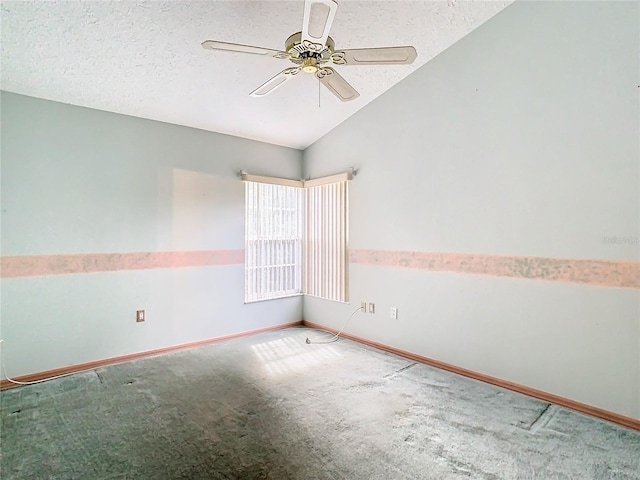 spare room featuring carpet floors, ceiling fan, vaulted ceiling, and a textured ceiling