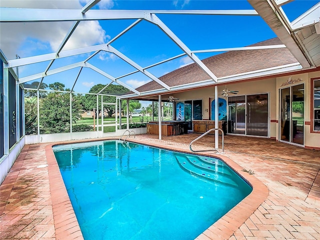 view of pool with a lanai, a patio, ceiling fan, and a jacuzzi