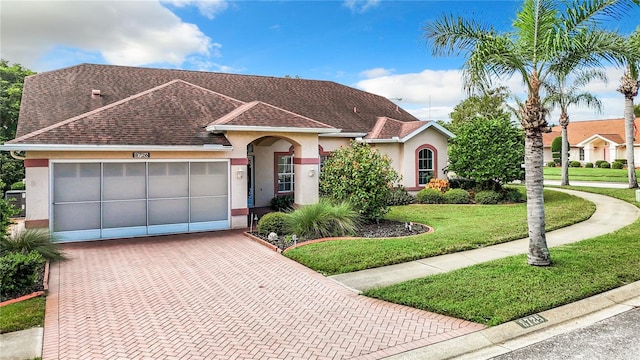 view of front facade with a front lawn and a garage