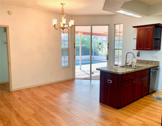 kitchen with sink, light hardwood / wood-style flooring, hanging light fixtures, a textured ceiling, and stainless steel dishwasher