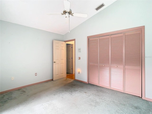 unfurnished bedroom with carpet floors, vaulted ceiling, a closet, and ceiling fan