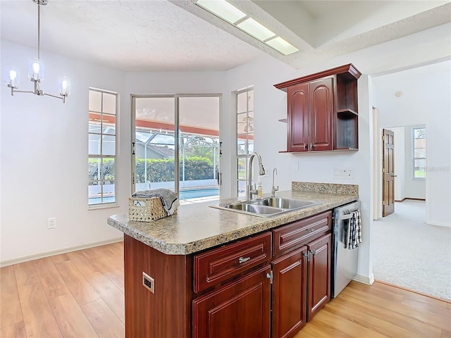 kitchen with open shelves, light countertops, light wood-style floors, a sink, and dishwasher