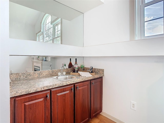 bar with indoor wet bar and a sink