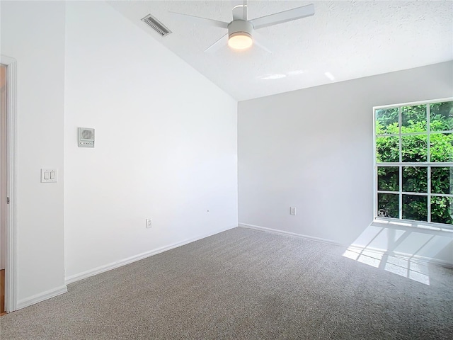 empty room with carpet floors, baseboards, visible vents, and a ceiling fan