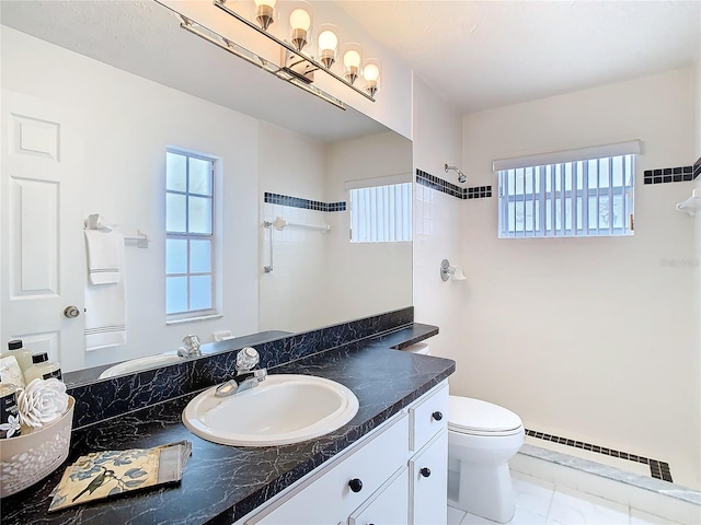 full bathroom featuring a shower, baseboard heating, and plenty of natural light