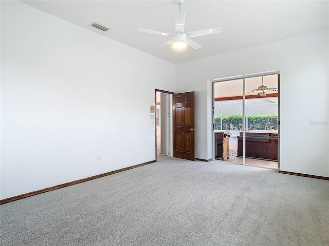 unfurnished room with baseboards, carpet flooring, visible vents, and a ceiling fan