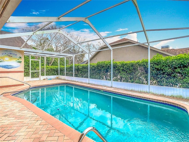 outdoor pool featuring a lanai and a patio