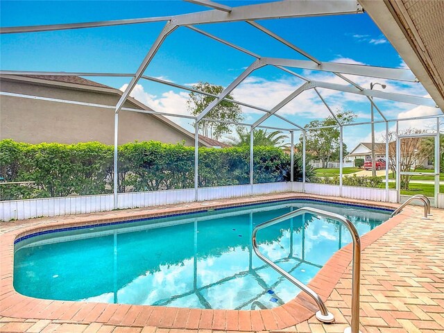 pool with a lanai and a patio area