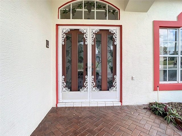 entrance to property with french doors and stucco siding