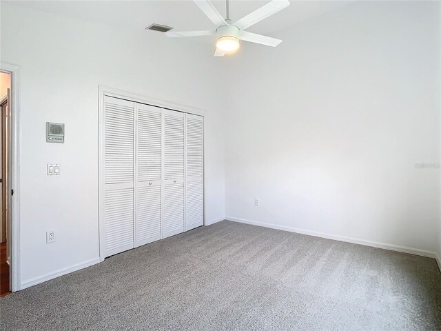 unfurnished bedroom featuring baseboards, a closet, visible vents, and carpet flooring