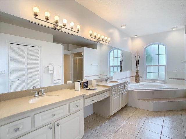 bathroom with double vanity, a stall shower, a sink, tile patterned flooring, and a bath